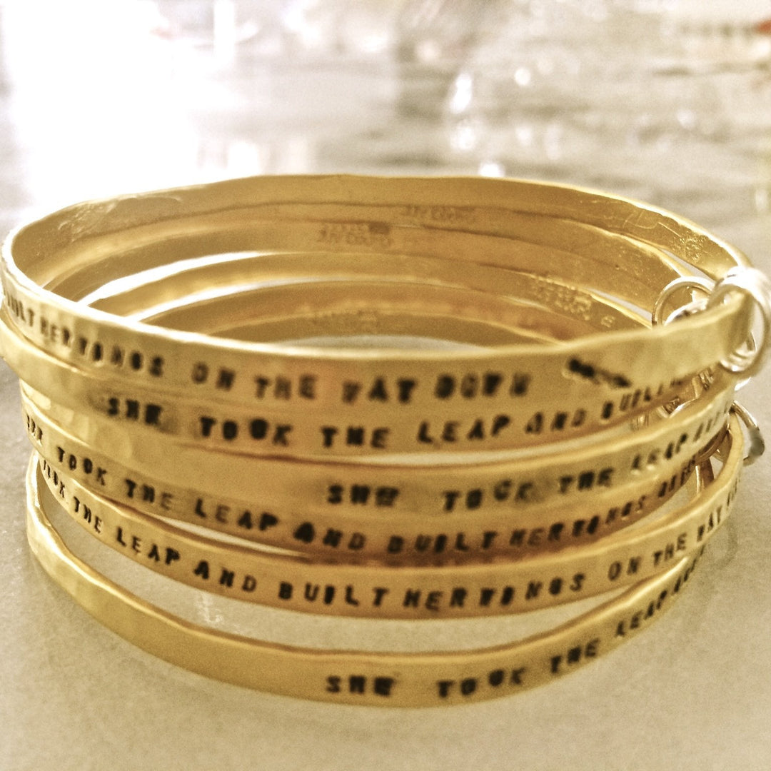 "She took the leap and built her wings on the way down" - three ring bangle